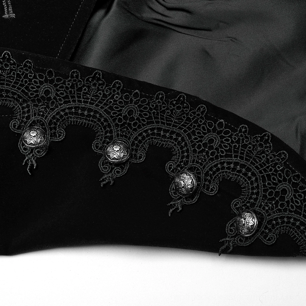 Velvet lace trim and decorative metal buttons on gothic jacket hem detail with satin lining visible