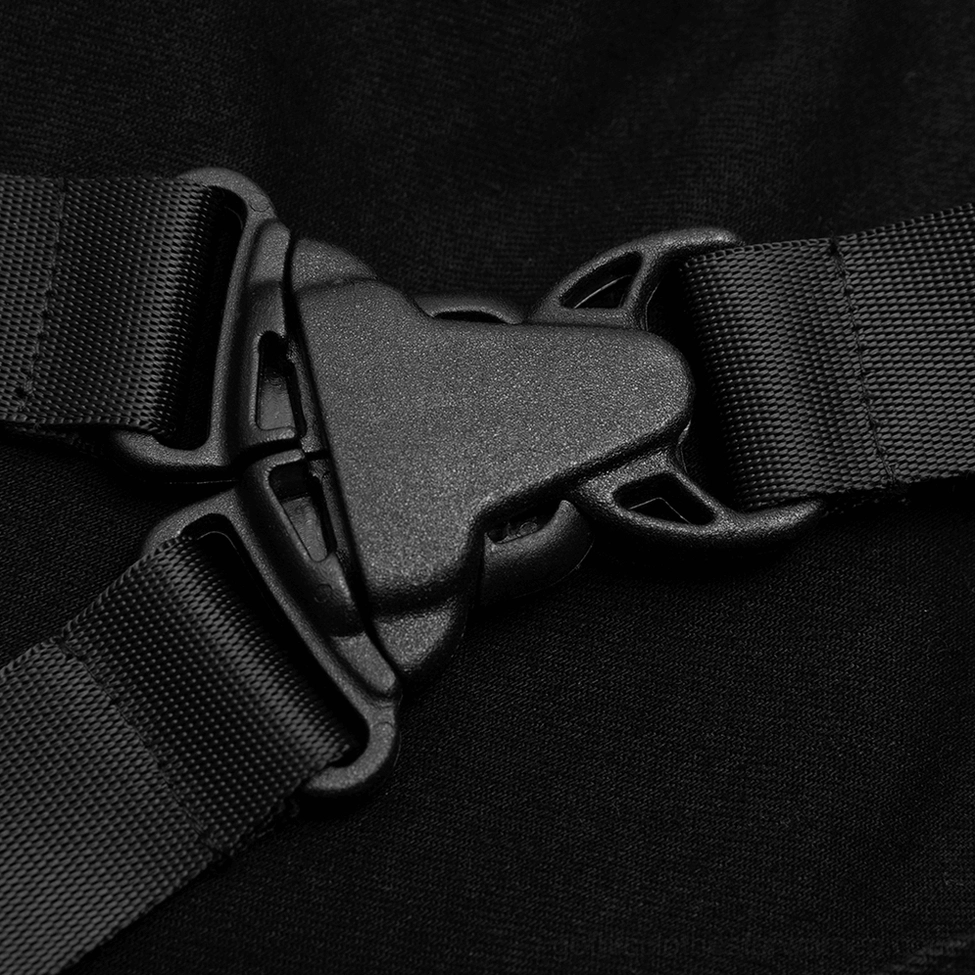Close-up macro detail of black plastic and metal tactical strap buckles on gothic denim jeans