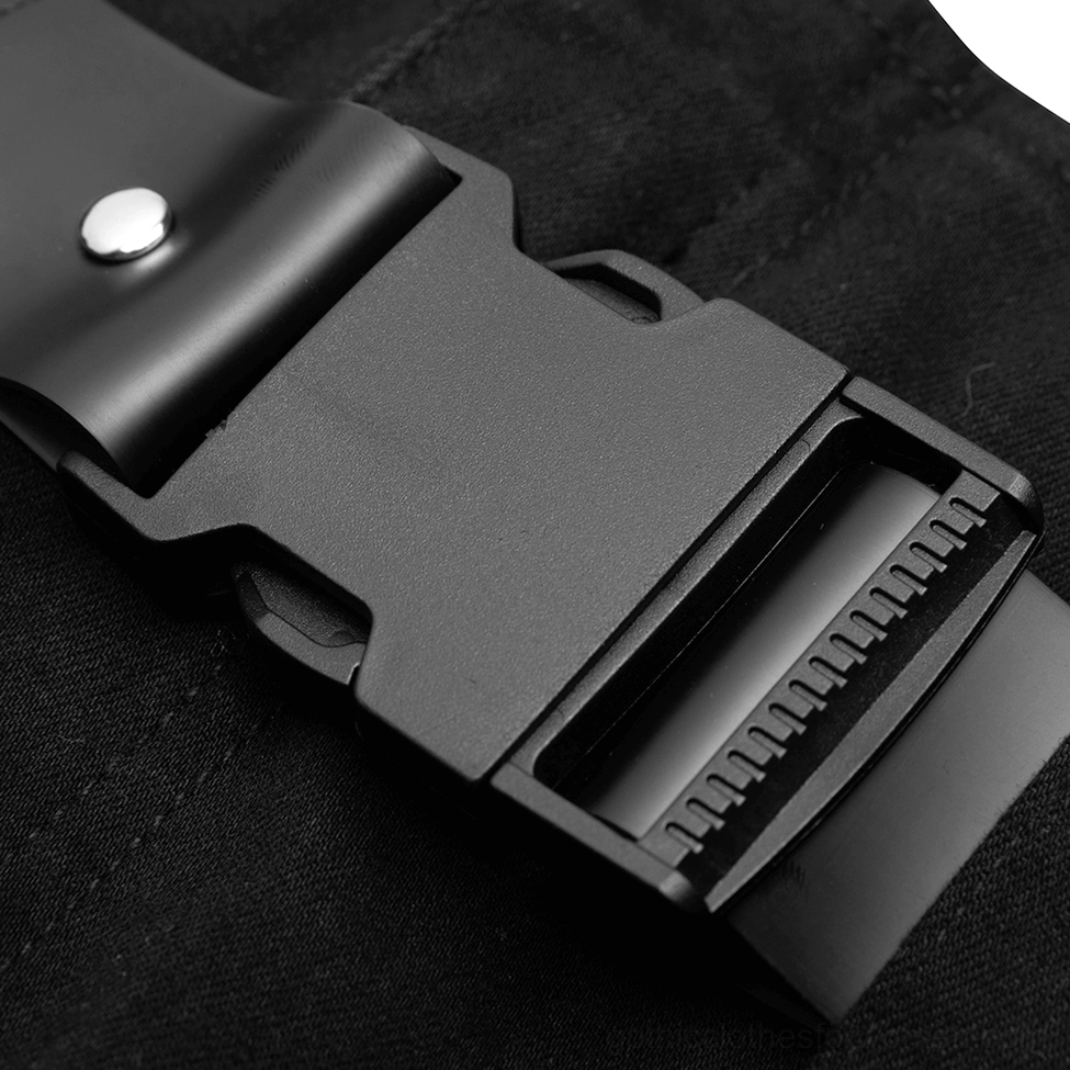 Macro close-up of matte black metal waist belt buckle and denim fabric texture on gothic jeans