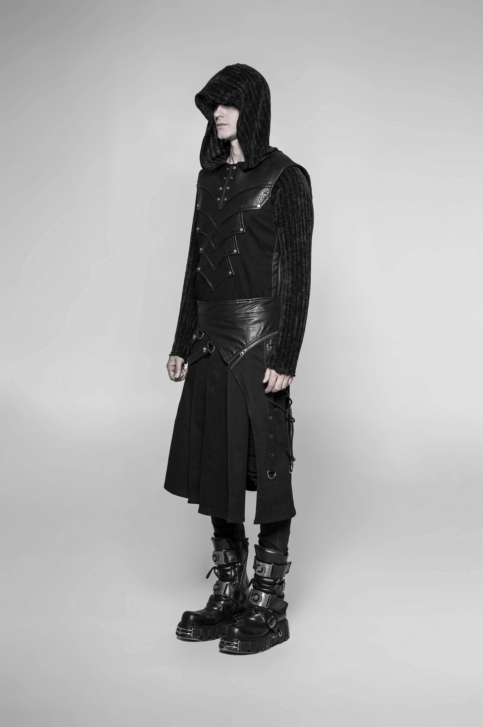 Detachable half kilt skirt in black displaying full-length pants conversion capability, showing structural integrity of woven twill and leather construction