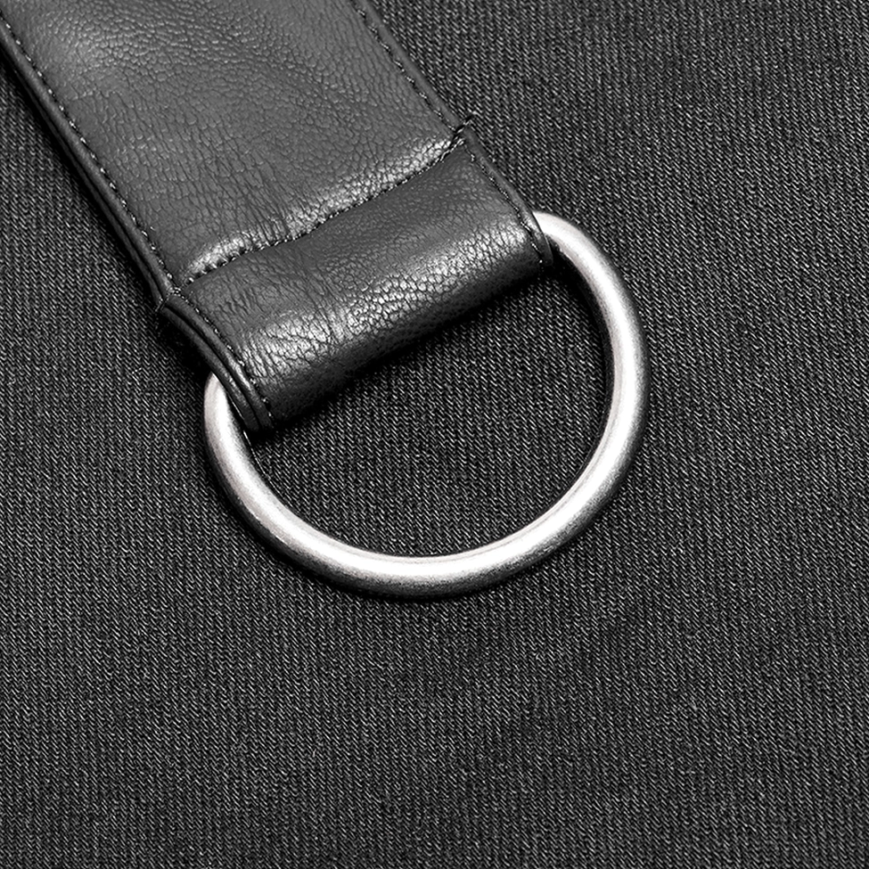 Close-up detail shot of Gothic kilt strap showing PU leather construction, metal D-ring attachment point, and textured woven fabric blend