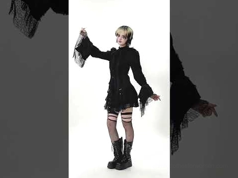 Gothic black lace blouse styled with alternative goth ensemble, including leg harness, combat boots, and fishnet stockings for complete dark aesthetic look