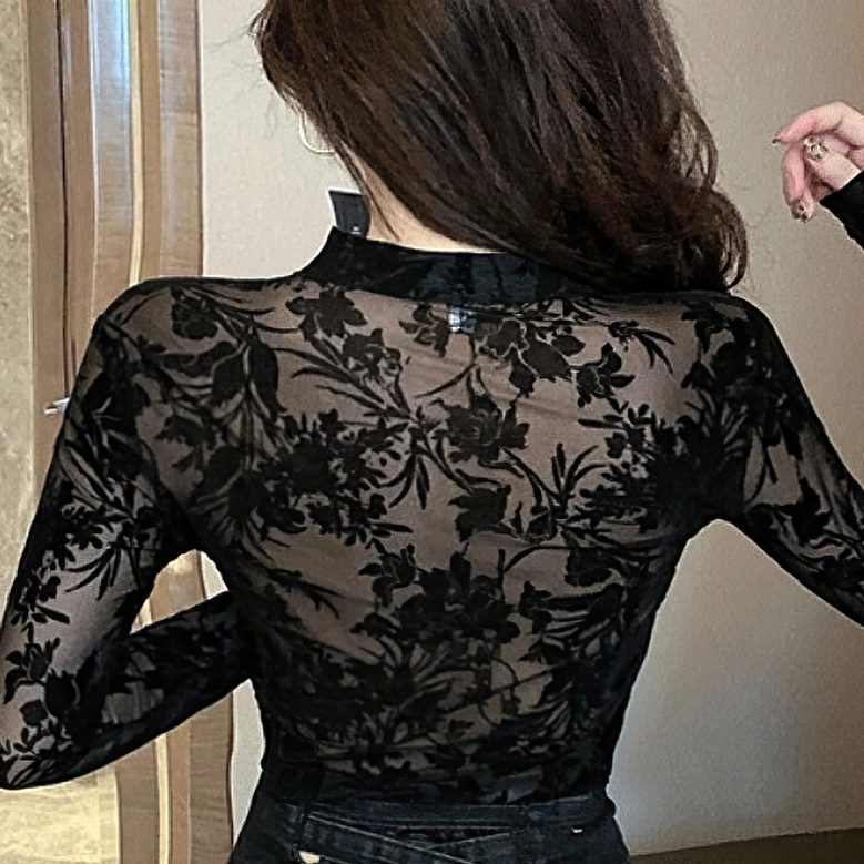 Black gothic lace blouse back view on model, showcasing sheer transparent mesh and symmetrical floral embroidery pattern from behind