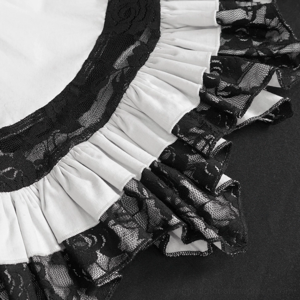 Detail shot of white lace ruffle blouse showcasing intricate black lace weaving and fabric texture