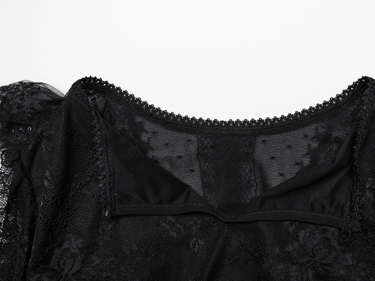Black lace blouse inner trim detail - scalloped edge and mesh lining close-up