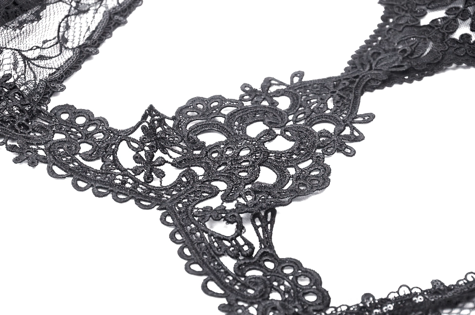 Detailed close-up of gothic black lace bolero neck trim featuring intricate baroque floral pattern on white background