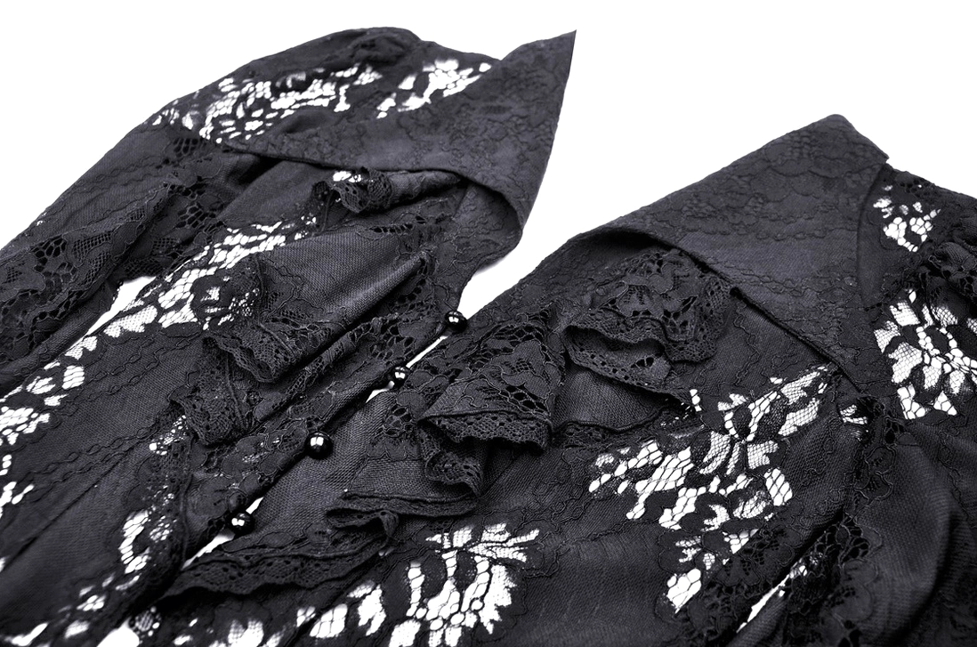 Close-up of gothic lace cape ruffled trim bead fasteners and floral lace texture details