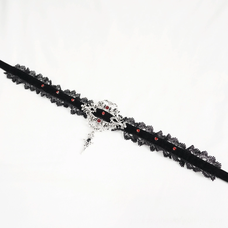 Top-down flat lay view of gothic lace choker showing complete strap design with small red gem accents and decorative silver cross pendant
