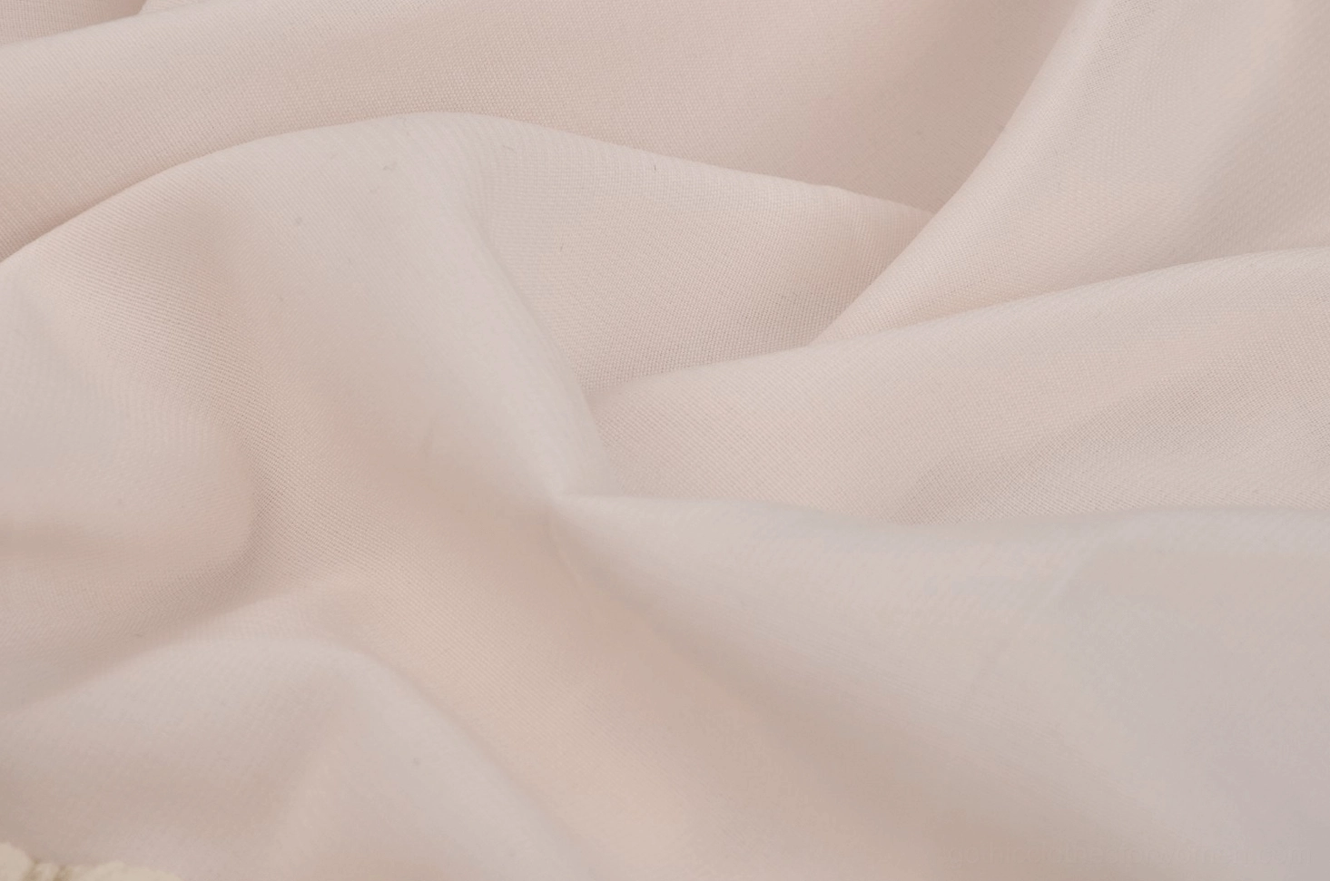 Macro texture detail of soft cream drapey woven lace fabric on gothic off-shoulder dress showing weave pattern