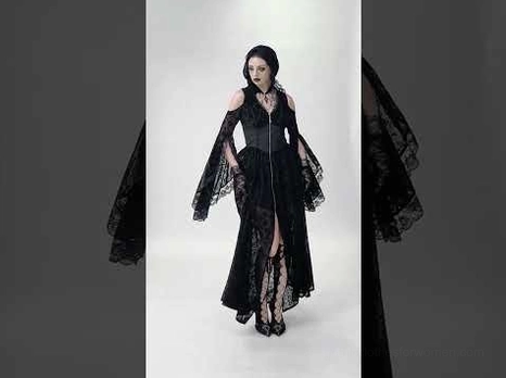 Black lace gothic maxi dress front medium shot on model with split hem and flared sleeves dark background