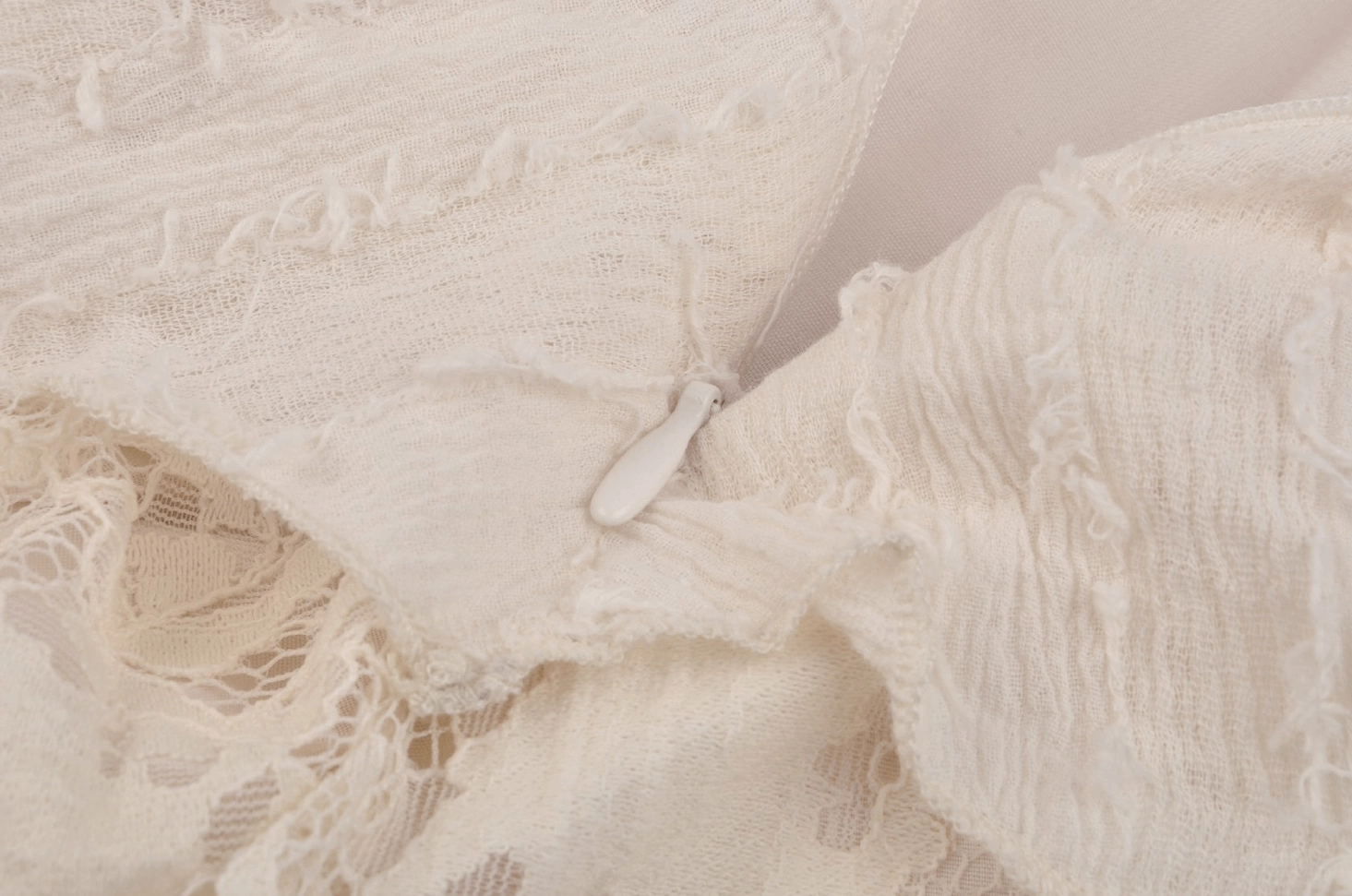 Gothic cream lace dress layered ruffles close-up showing architectural volume and alternative fashion design