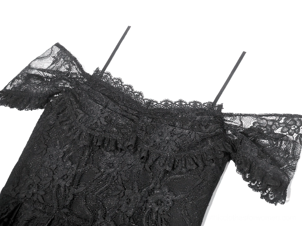 Close-up detail of black gothic lace dress neckline, showing spaghetti straps and ruffled lace trim of off-shoulder design