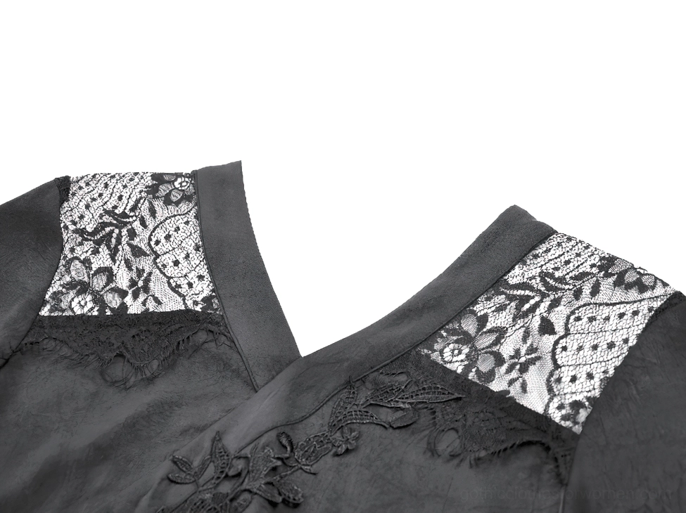 Close-up detail of gothic lace V-neckline with floral lace panel on black dress