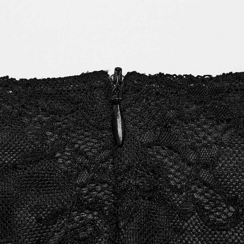 Close-up of black concealed back zipper with floral lace base on gothic dress