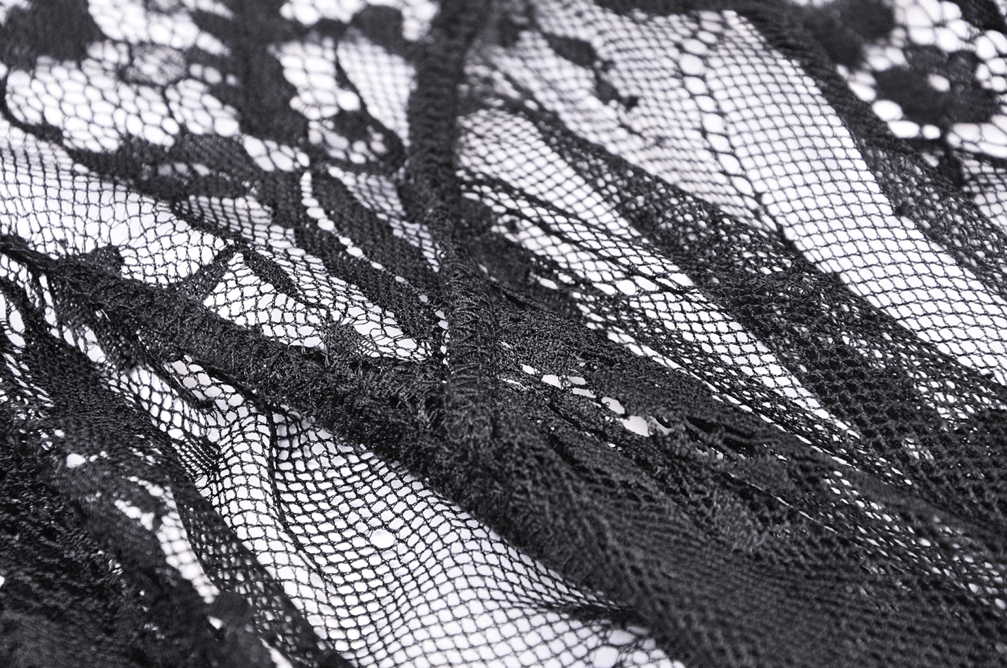 Intricate black floral lace embroidery detail - angled close-up view