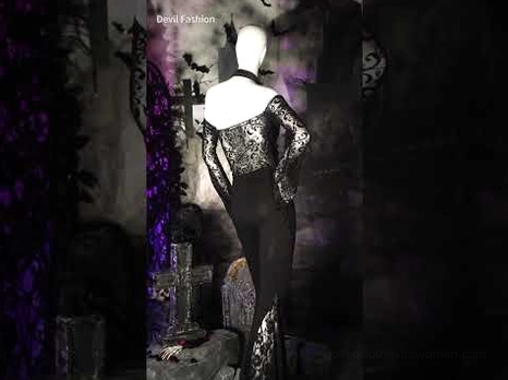 Full outfit styling with black gothic cross lace flare leggings paired with off-shoulder corset top in dark graveyard gothic scene with mannequin display