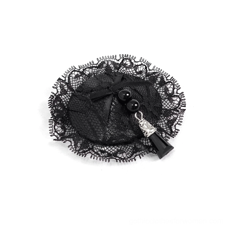 Single black lace nipple cover with metal tassel pendant close-up detail shot