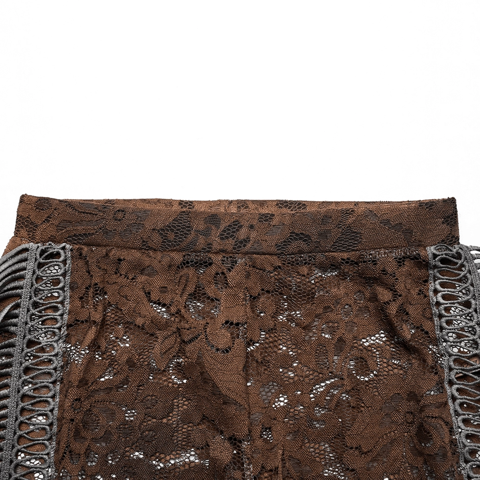 Close-up detail of high waistband with lace texture and side fringe trim on gothic flare pants