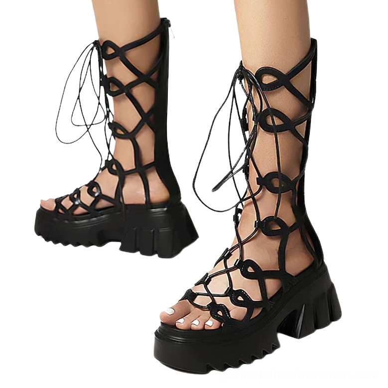 Black platform sandals with intricate crisscross lace straps and serrated sole, front overhead view