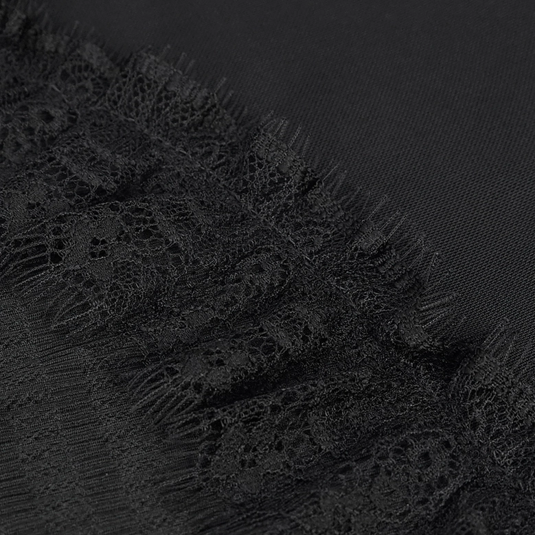 Black gothic lace raglan sleeve close-up showing fringed lace overlay and stretch fabric construction