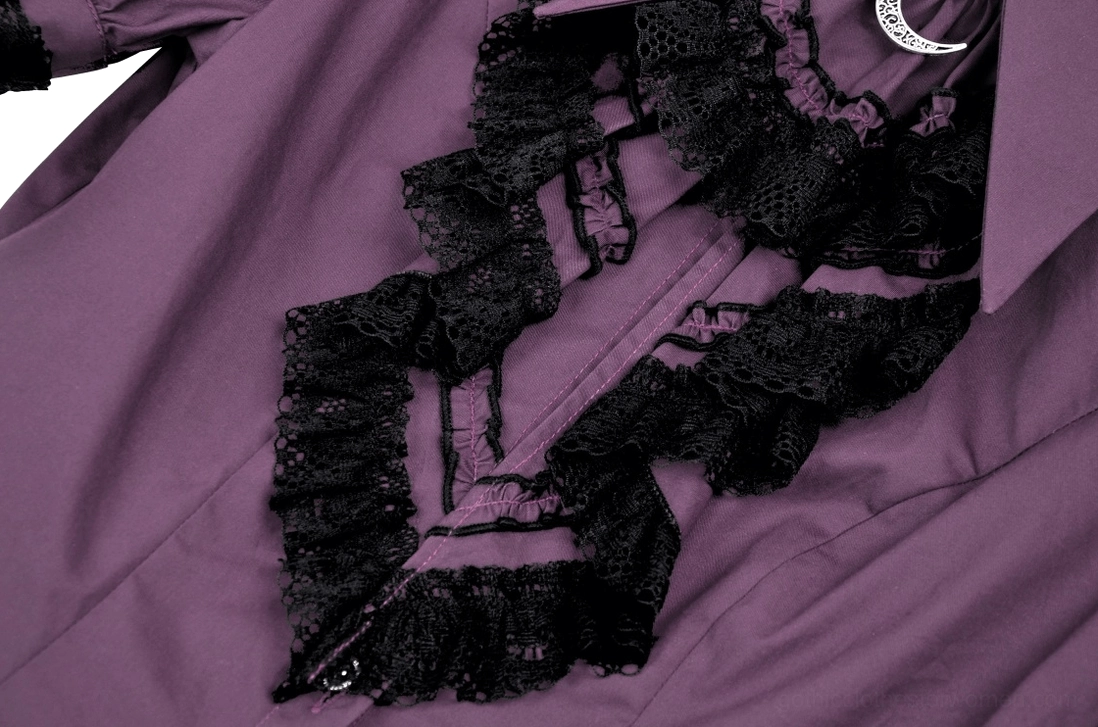Close-up side view of layered black lace ruffle trim with metal crescent accent detail on purple fabric