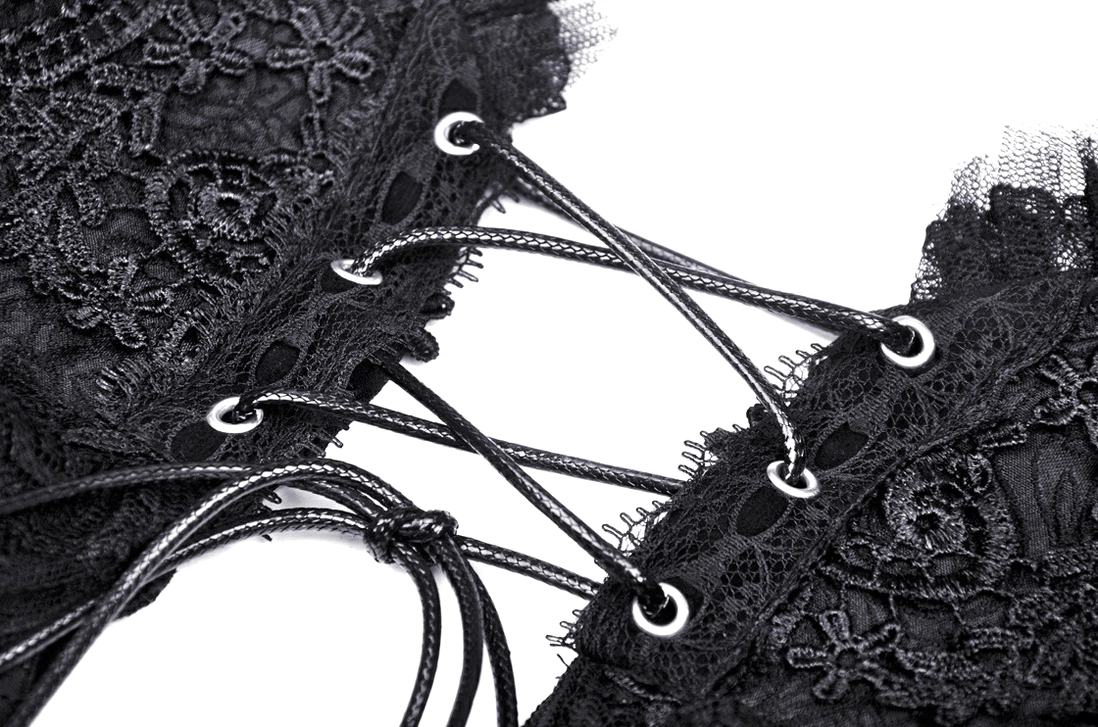 Macro close-up of braided leather corset lacing system on embroidered lace fabric