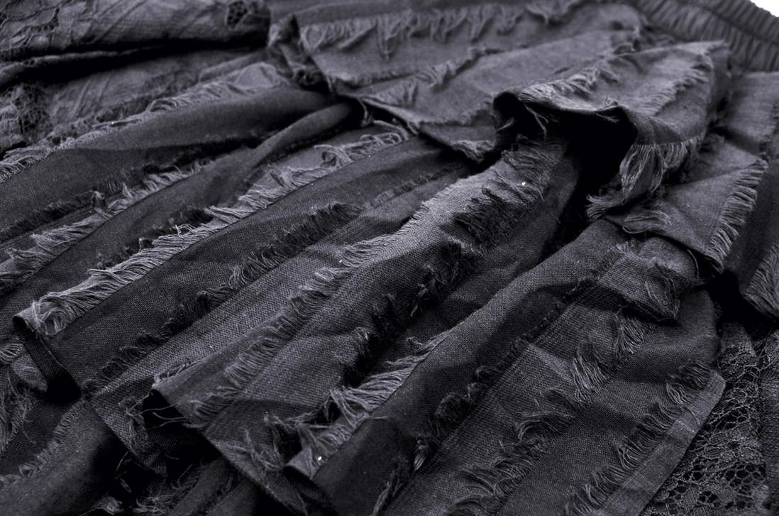 Black gothic skirt ruffle and pleat details showing layered ruffles with frayed edges