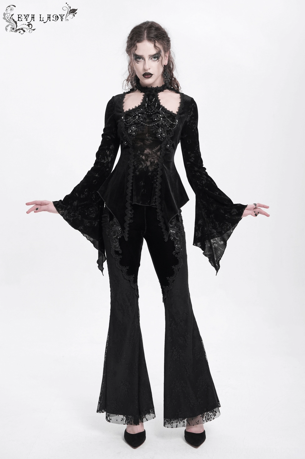 Close-up of black gothic lace top asymmetric hemline and dark velvet construction details