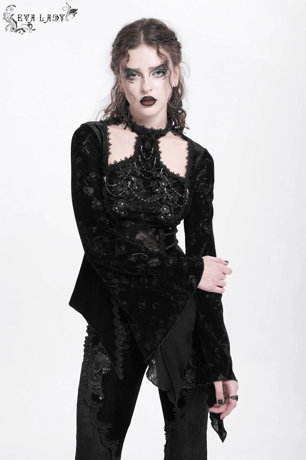 Side view close-up of black gothic lace top showing layered lace panels and structural design elements
