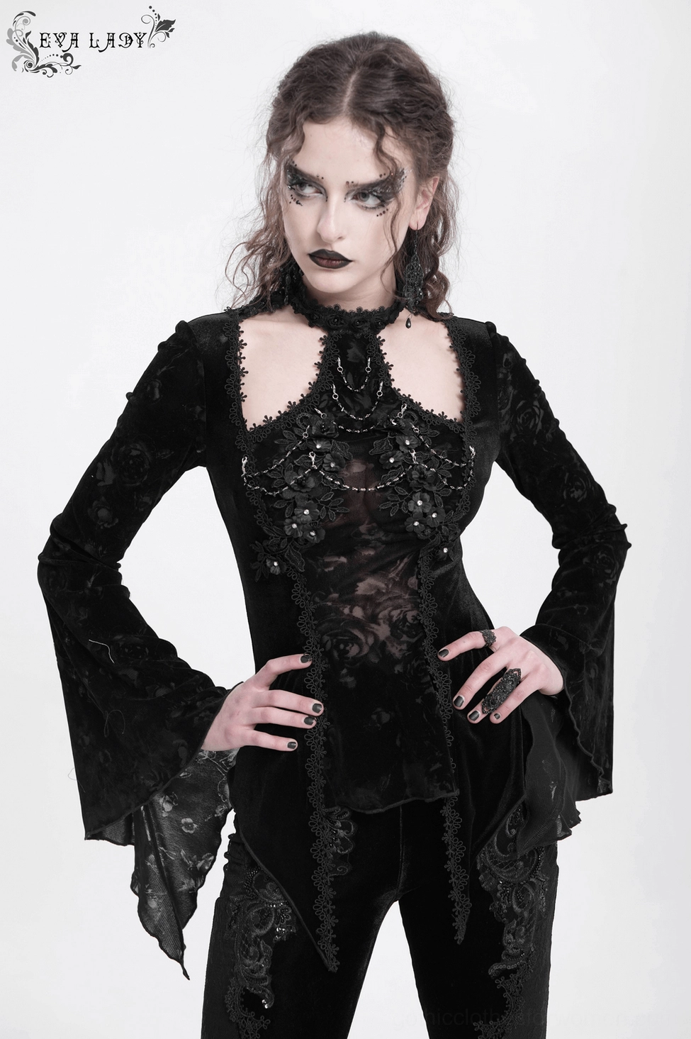 Three-quarter view of black gothic velvet lace top displaying halter neckline and fitted waist construction