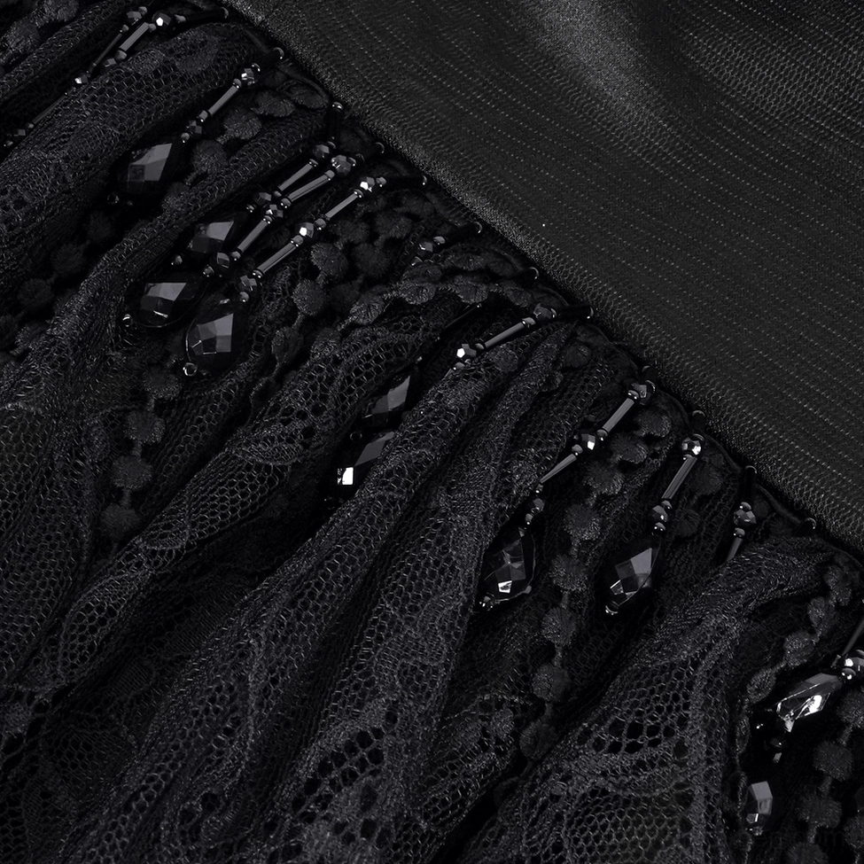 Close-up detail of gothic lace trim with black crystal bead ornaments and floral lace texture on satin backing