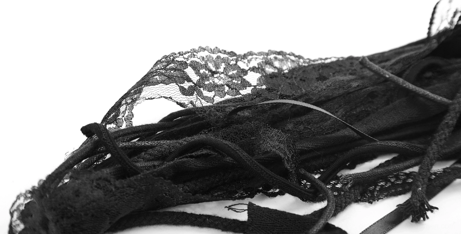 Close-up flat lay of gothic hair accessory base showing black sheer lace trim and adjustable straps details