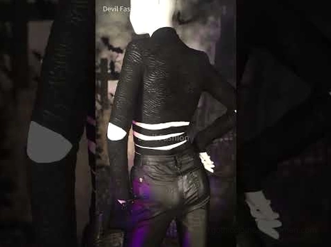 Black lace-up gothic skinny pants partial back view styled in dark gothic indoor scene with full alternative outfit