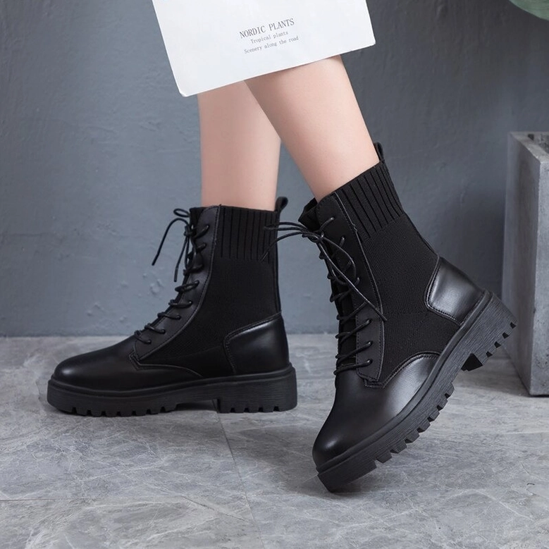 Women modeling black gothic lace-up combat boots - platform ankle boots side rear view with knitted shaft