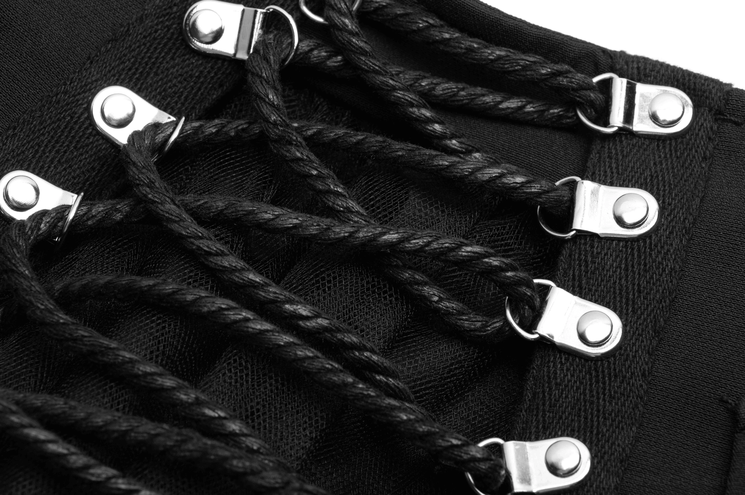 Black gothic lace-up skirt braided rope lacing and metal eyelet closure system detailed close-up view