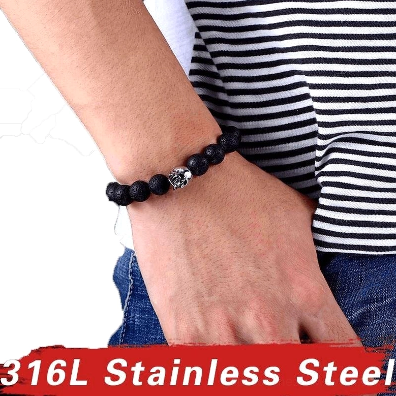 Unisex gothic lava stone skull bracelet worn on male wrist - side view showing fit and everyday wear potential