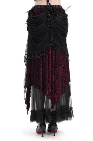 Victorian gothic layered maxi skirt rear full view showing asymmetric high-low hem, beaded tassel trim, and floral waist embellishments