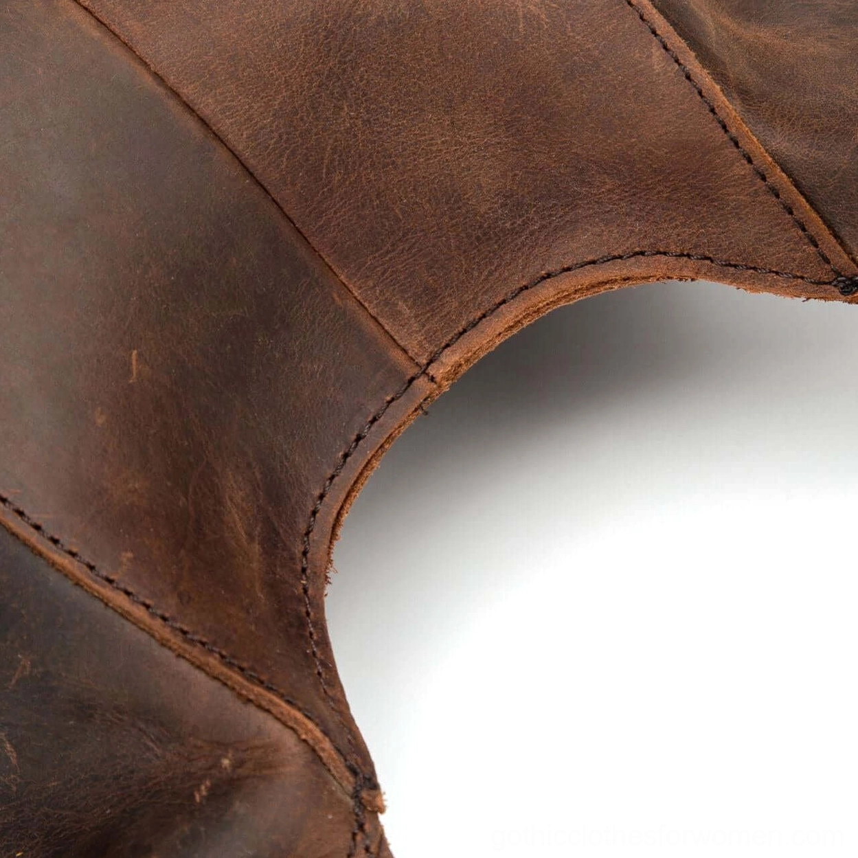 Dark brown leather gothic backpack closure system detail showing zipper mechanism and craftsmanship