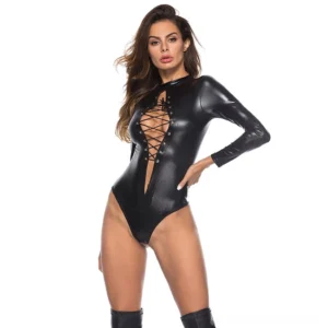 Black gothic faux leather bodysuit with lace-up corset front cutout, long sleeves, worn by model on white studio background