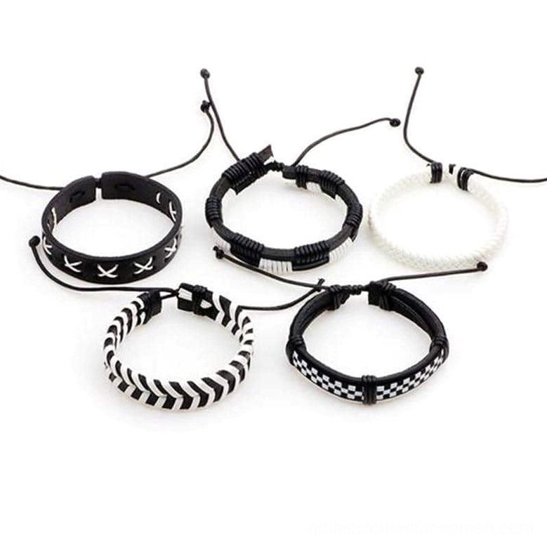 Five adjustable black and white woven leather bracelets with sliding knot closures and mixed geometric designs displayed flat lay