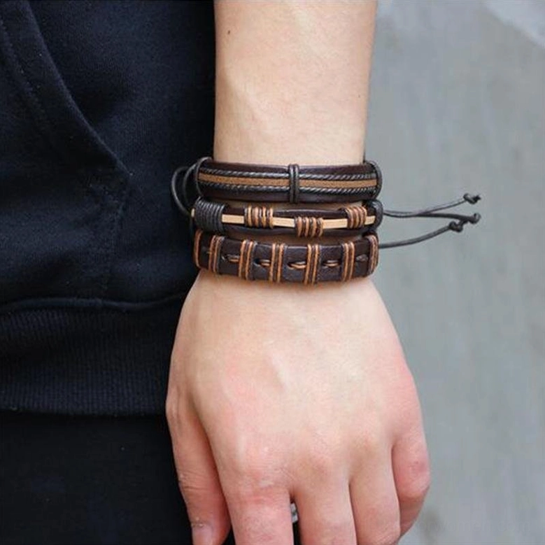 Male model wearing stacked brown leather gothic bracelets on wrist, demonstrating adjustable drawstring ties and braided rope details in side close-up