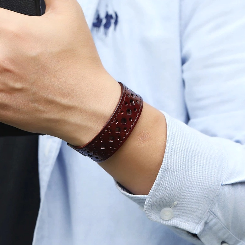 Unisex wrist wearing dark brown vintage geometric leather cuff bracelet in everyday wear, comfortable fit demonstration