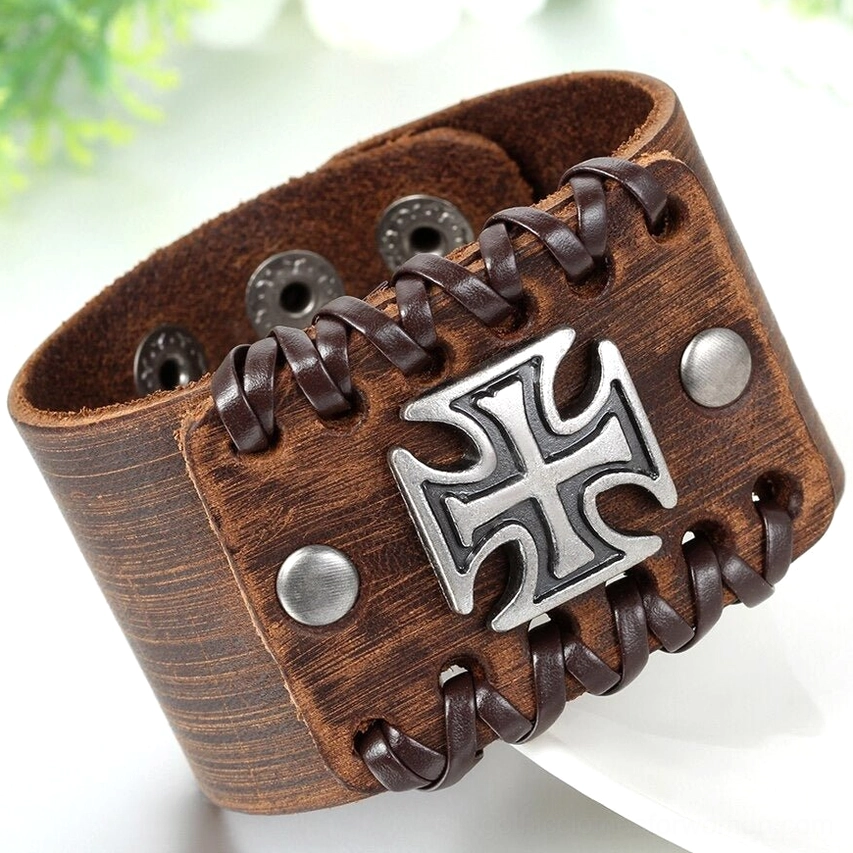 Two gothic leather cuff bracelets - black and brown with Celtic cross charm - paired display on white background