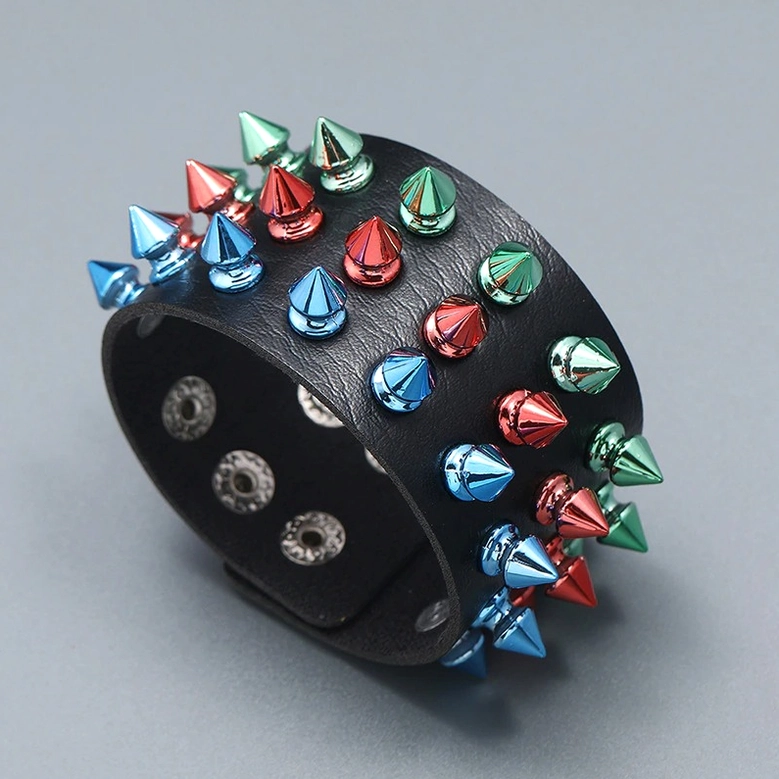 Black leather gothic cuff with multicolor metal spikes front view, snap fastener detail and geometric spike pattern