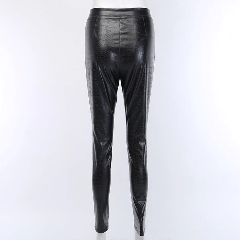 Back view of black high-waist gothic faux leather pencil pants on mannequin, crocodile grain texture, skinny fit from hip to ankle