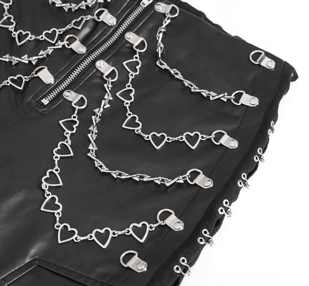 Close-up of side lace-up studs and silver buckles on black gothic faux leather pants