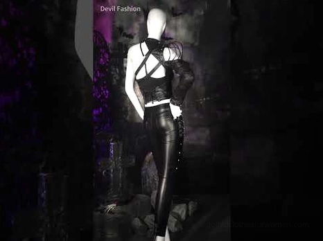 Women's gothic chain faux leather pants styled with black camisole on mannequin