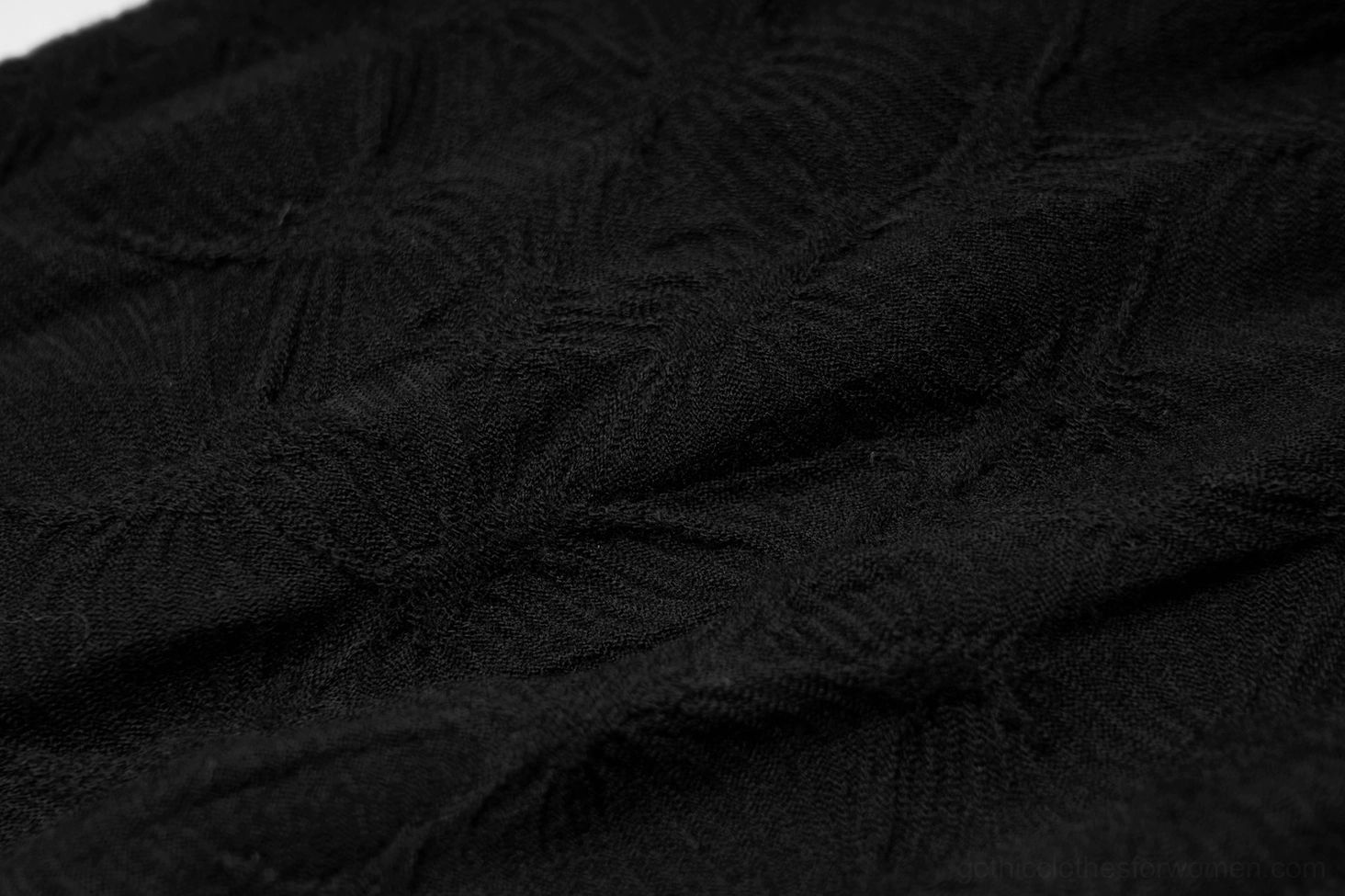 Macro shot revealing subtle damask jacquard woven texture throughout the black gothic leg warmer fabric