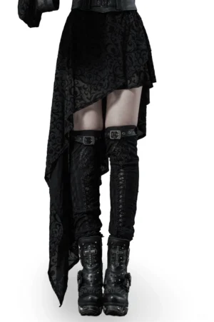 Black gothic knee-high leg warmers with metal buckle straps worn with platform boots and alternative skirt, front view on model