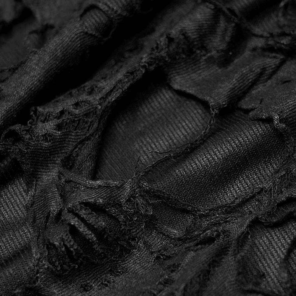 Macro texture shot of black gothic leg warmers showing distressed woven fabric construction with sheer mesh underlayer detail